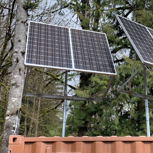 Off grid solar panels mounted beside trees