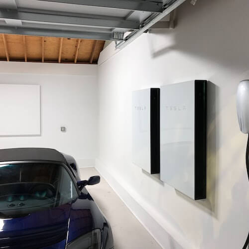 Tesla power wall installation on garage wall